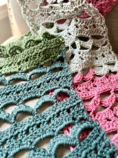 lacy crochet pattern scarf in blues, pinks, greens and creams