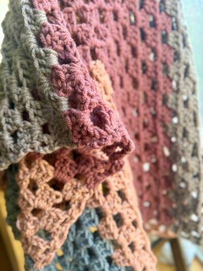 detail image of chunky crochet blanket in warm colors