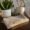 crochet hand towel in neutral tones on a kitchen table