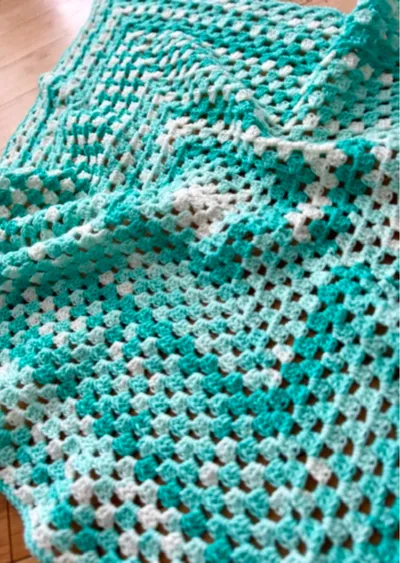 blue and white granny stitch crochet baby blanket in blue