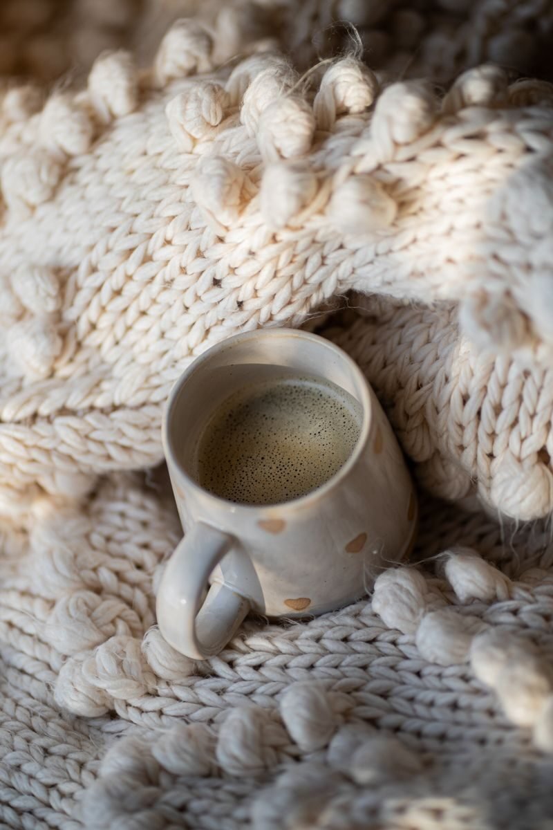 cozy crochet self-care setup with crochet comfy blanket and coffee