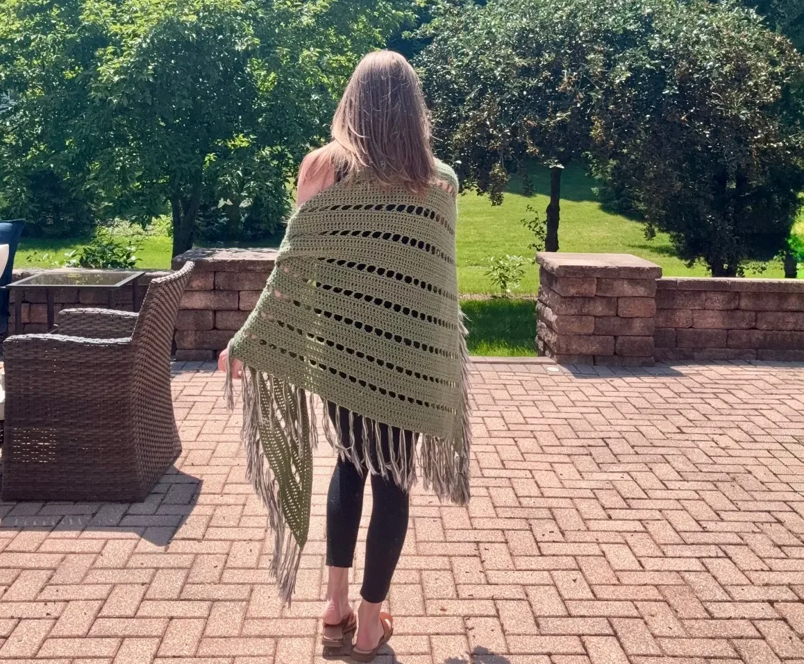 custom made green crochet wrap on woman outside