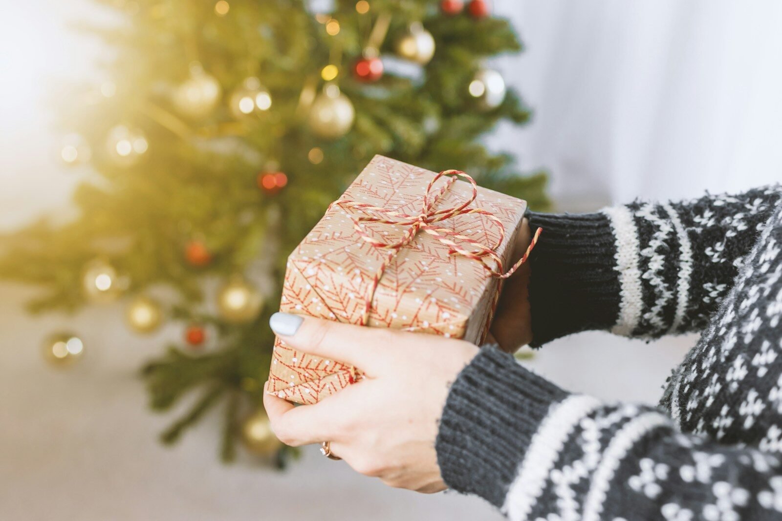 person holding gift with handmade crochet gift inside